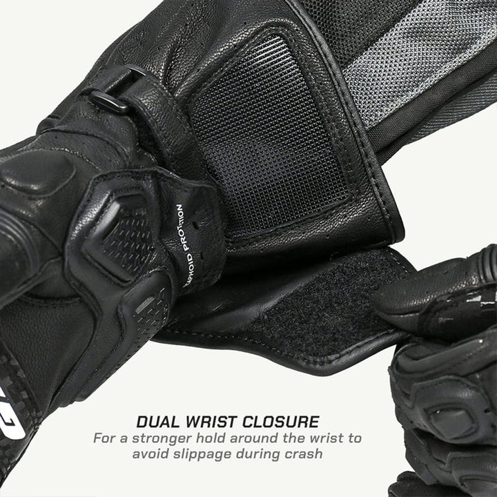 Close-up of black motorcycle gloves with dual wrist closure feature on a white background